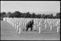 An American veteran of D-Day photographs a headstone at the Omaha Beach cemetary 1979 - ©2025 David Burnett.<br/>All rights reserved.