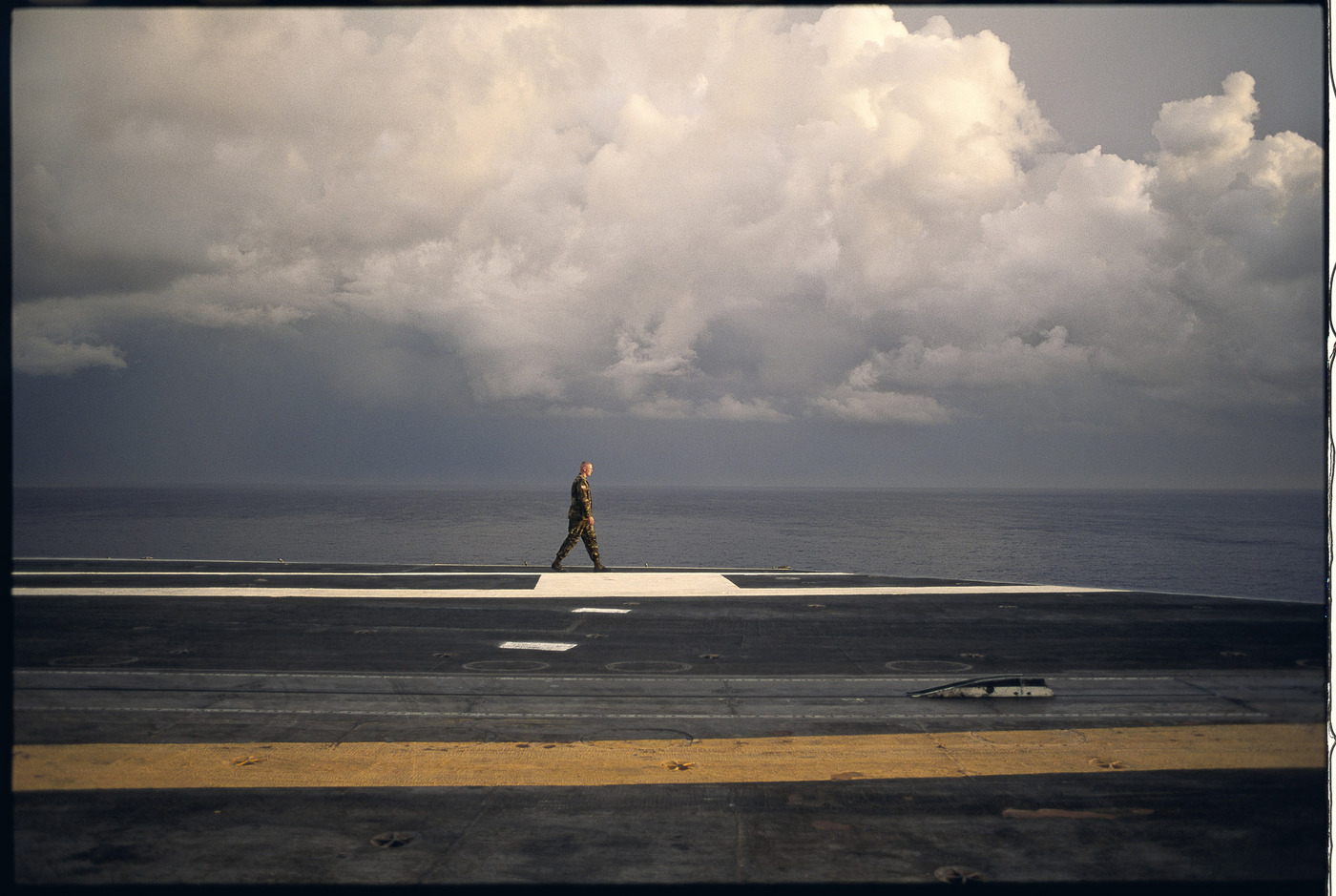 A long Marine walks along the deck of the U S S Eisenhower, en route to Haiti, 1994 : Too Close UMFA : David Burnett | Photographer