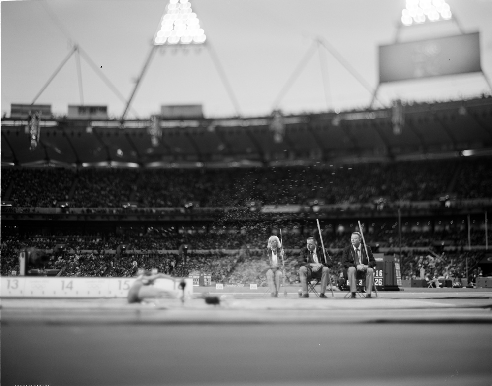 The sand raking squad makes ready for the next Lady's Triple Jumper  : London 2012 / Olympics : David Burnett | Photographer