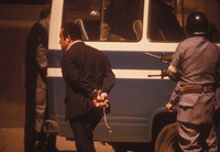 A political prisoner is led into the Defense ministry after his arrest.