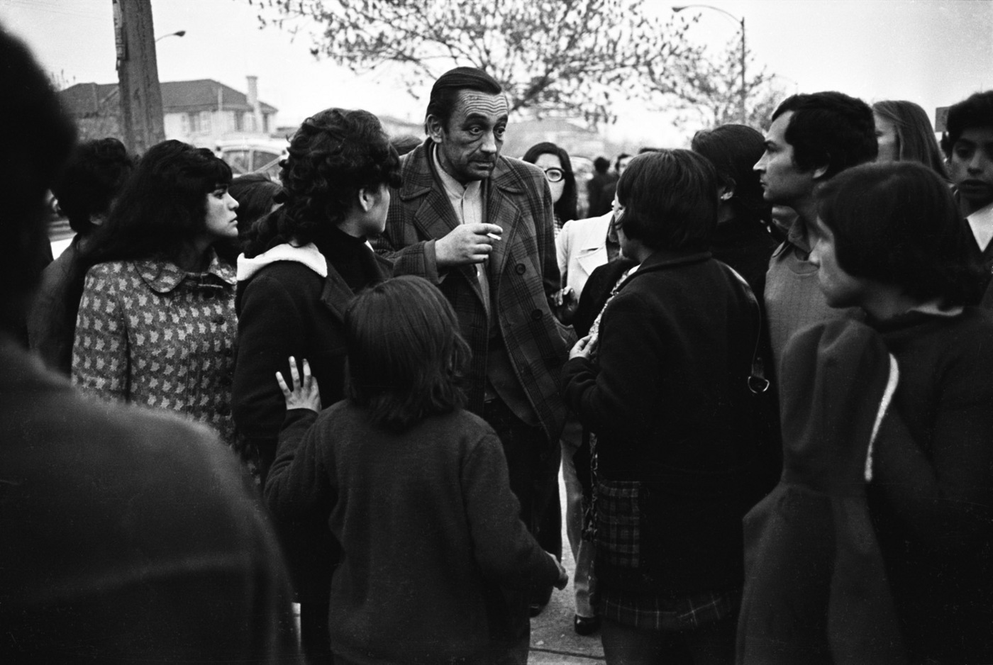 A released prisoner tells expectant loved ones what he saw inside the stadium. : Chile: 40 Years After the Coup d'Etat : David Burnett | Photographer