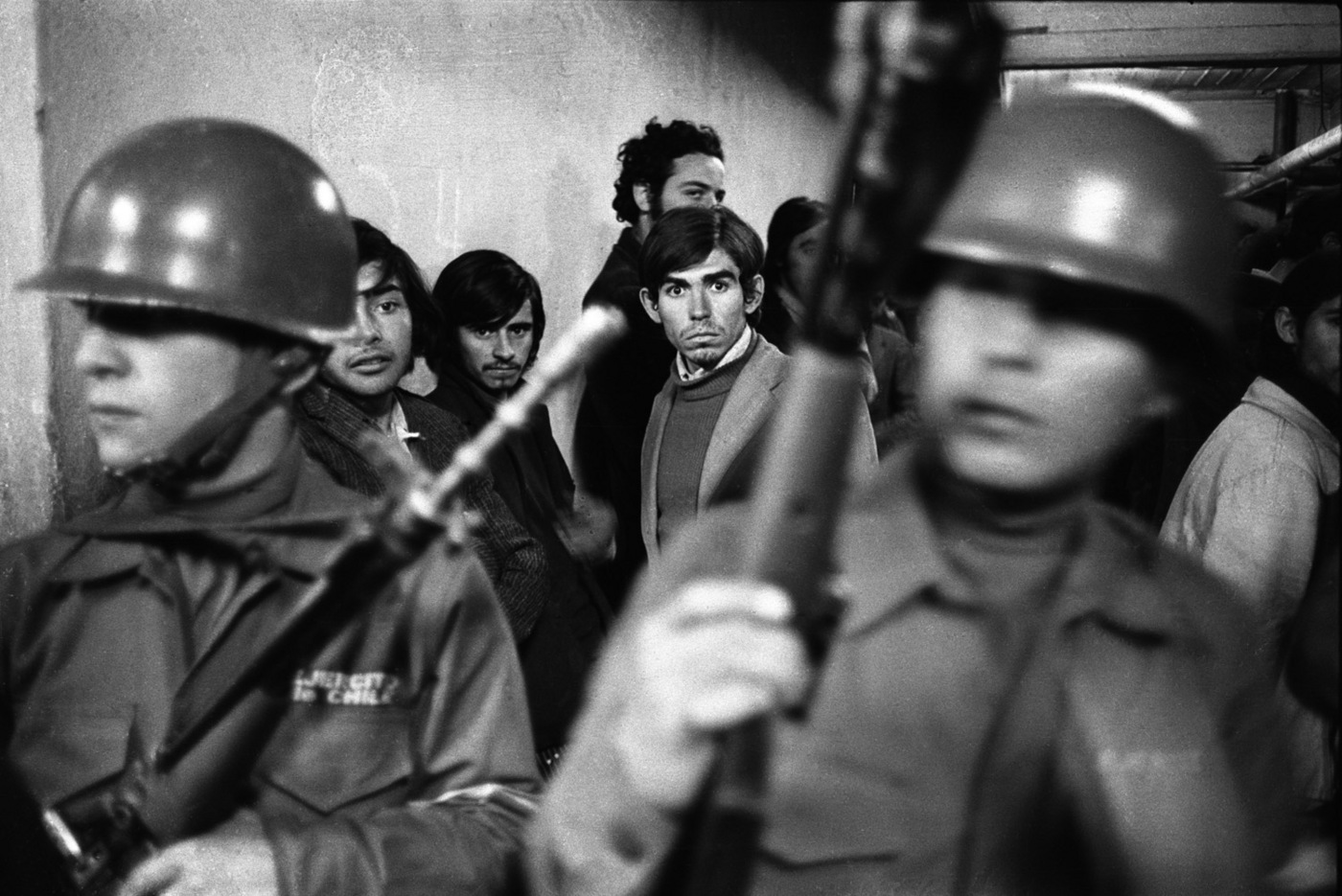 Young lab workers, arrested as potential "extremists" are brought into the National Stadium. : Chile: 50 Years After the Coup d'Etat : David Burnett | Photographer