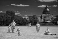 A tourist family on the Mall in front of the Air & Space Museum, the Capitol in the distance - ©2024 David Burnett.<br/>All rights reserved.