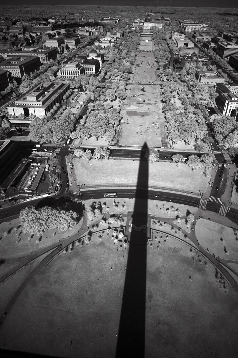 The shadow of the Washington Monument drapes East across 14th street, just one mile from the Capital in the distance : The National MALL : David Burnett | Photographer