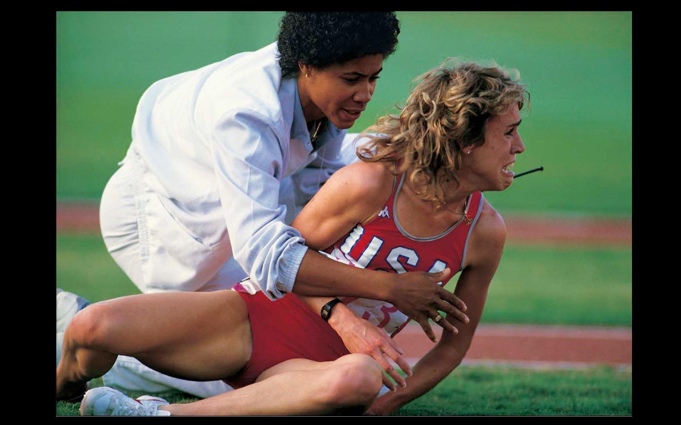 Famed American long distance runner Mary Decker lays in agony beside the track infield, after her collision with Zola Budd  LA Olympics 1984 : Looking Back: 60 Years of Photographs : David Burnett | Photographer