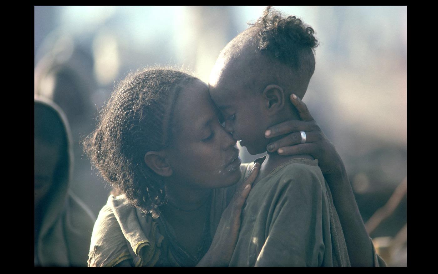 Even in a wretched refugee camp, a mother's love is present.  Ethiopia  1984 : Looking Back: 60 Years of Photographs : David Burnett | Photographer