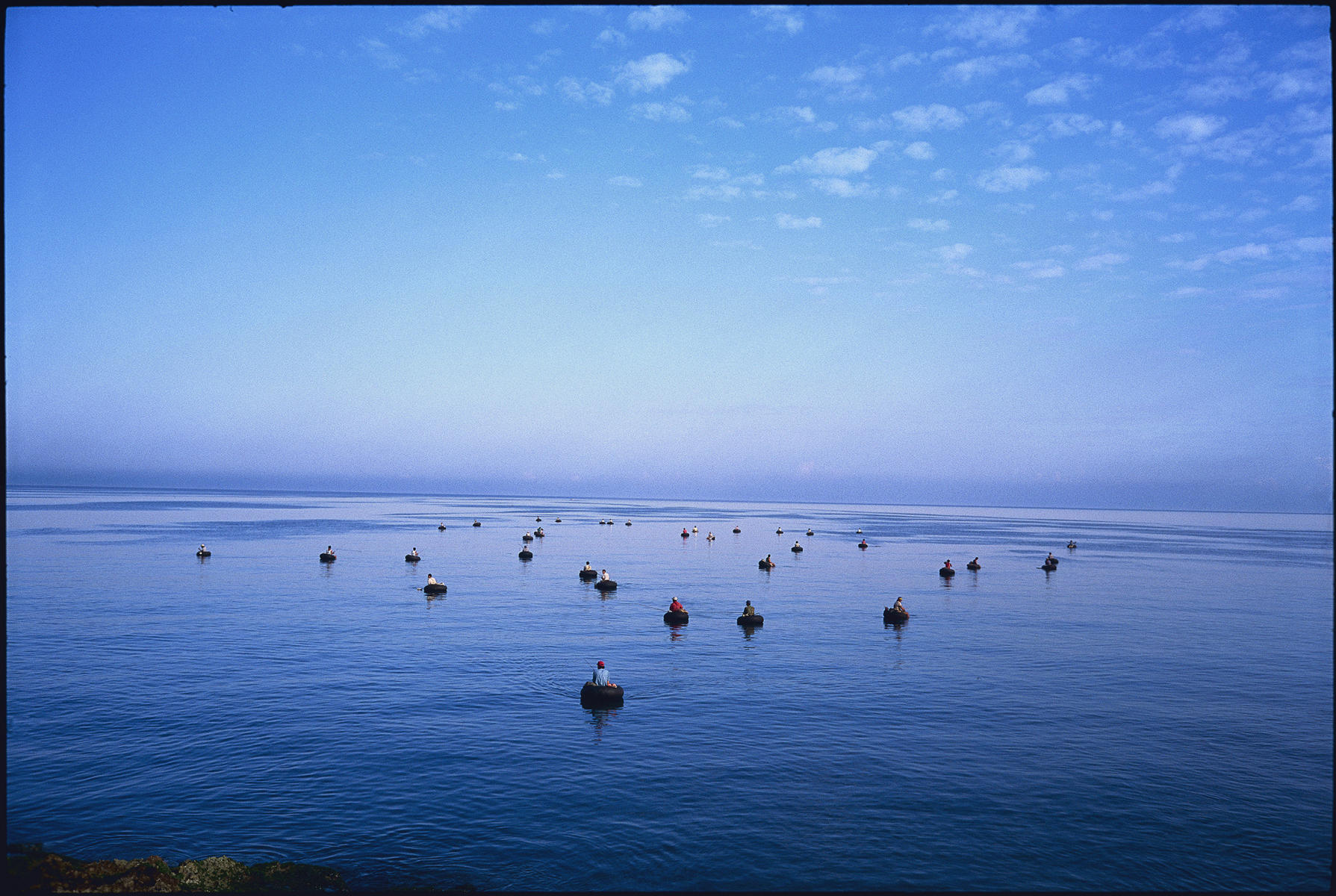 Cuban fishermen figure out where theres a will, theres a way: Fishing from inner tubes, Havana Harbor : Looking Back: 60 Years of Photographs : David Burnett | Photographer