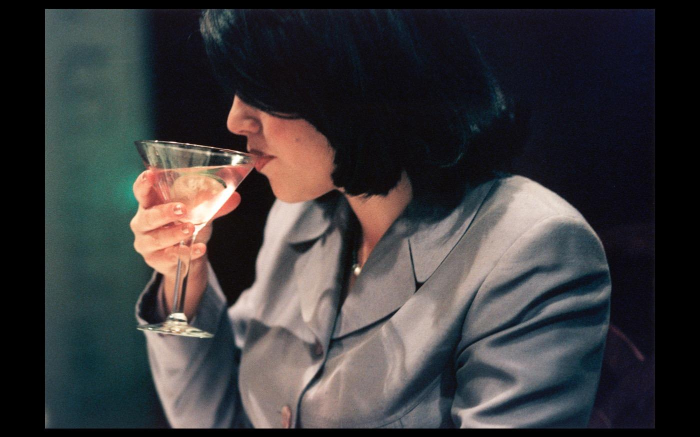 Former White House intern Monica Lewinsky sips a cosmo at Mortons/DC following the explosive news of her affiar with Bill Clinton 1998 : Looking Back: 60 Years of Photographs : David Burnett | Photographer