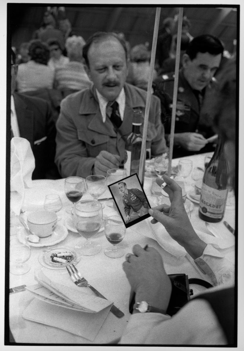 In 1974, at the 30th anniversary of D-Day, an American vet shares a picture of himself as a young man, with a French woman, at a lunch offered by a French village to thank the troops 1974. : Looking Back: 60 Years of Photographs : David Burnett | Photographer