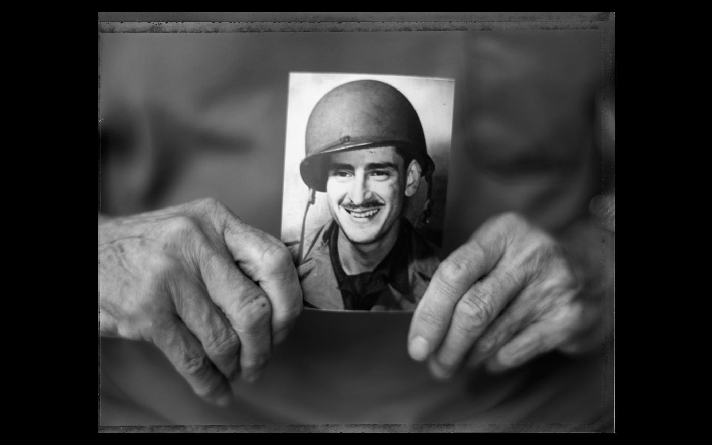 Former soldier Harry Parley holds a picture of himself as a young soldier  2004 : Looking Back: 60 Years of Photographs : David Burnett | Photographer