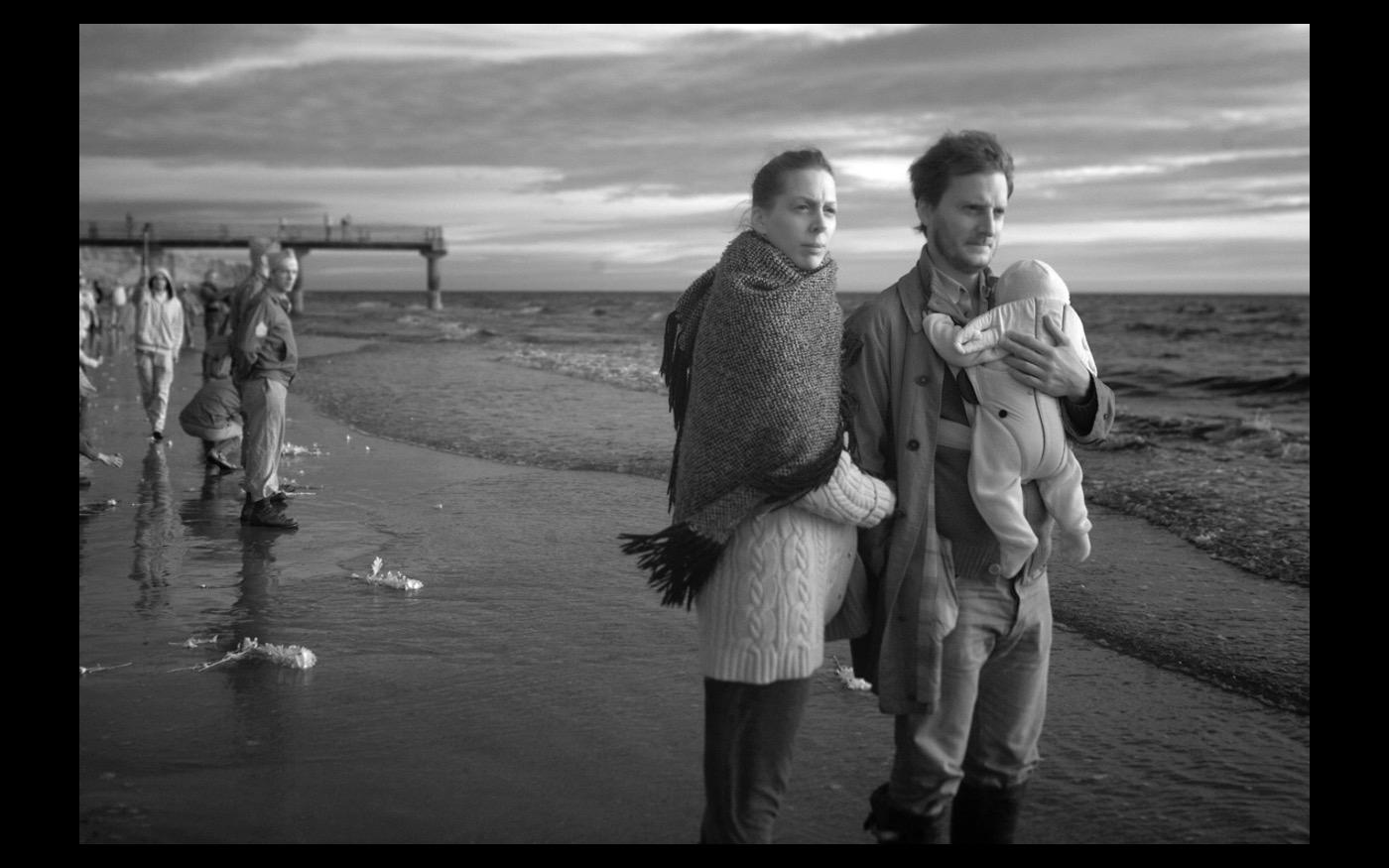 A young couple wanders along Omaha Beach at H hour, early in the morning of June 6 2019  the 75th Anniversary of D-Day : Looking Back: 60 Years of Photographs : David Burnett | Photographer