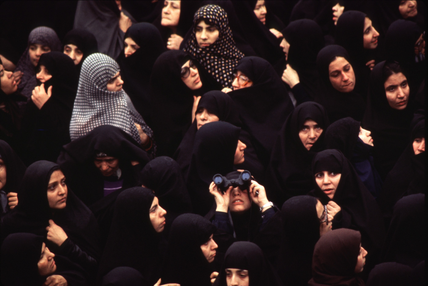 Outside Khomeini's room at the school, hundreds of chador-clad women gather to see a glimpse of the Ayatollah. : 44 Days: the Iranian Revolution : David Burnett | Photographer