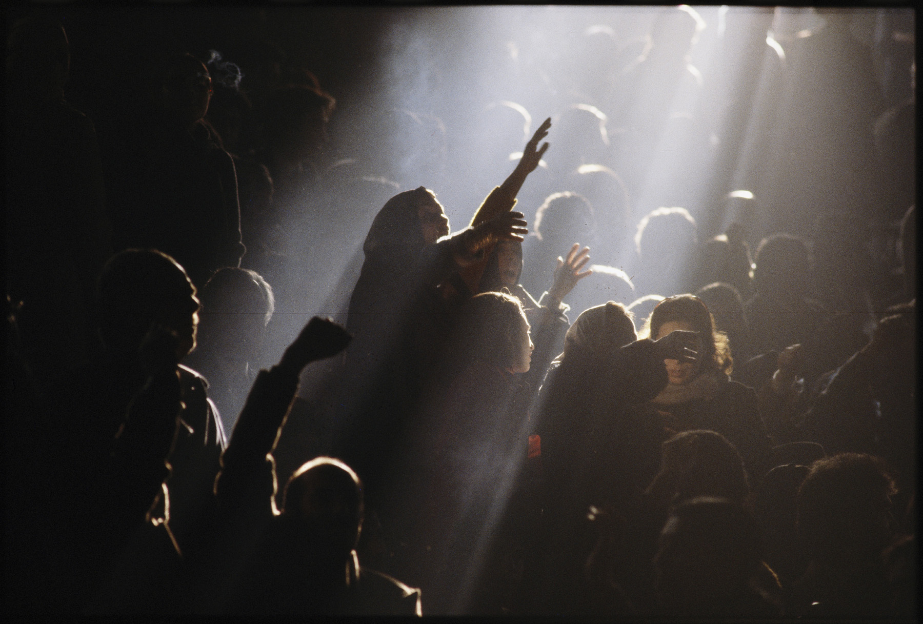 At a pro-Shah rally, a woman rises to cheer him. : 44 Days: the Iranian Revolution : David Burnett | Photographer