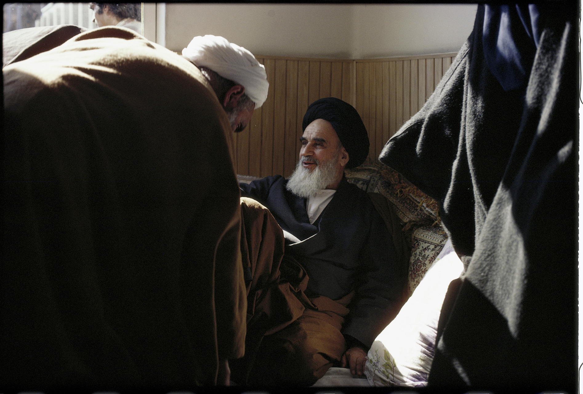 In the small school where he kept his offices after arriving in Tehran, Khomeini greets visitors. : 44 Days: the Iranian Revolution : David Burnett | Photographer